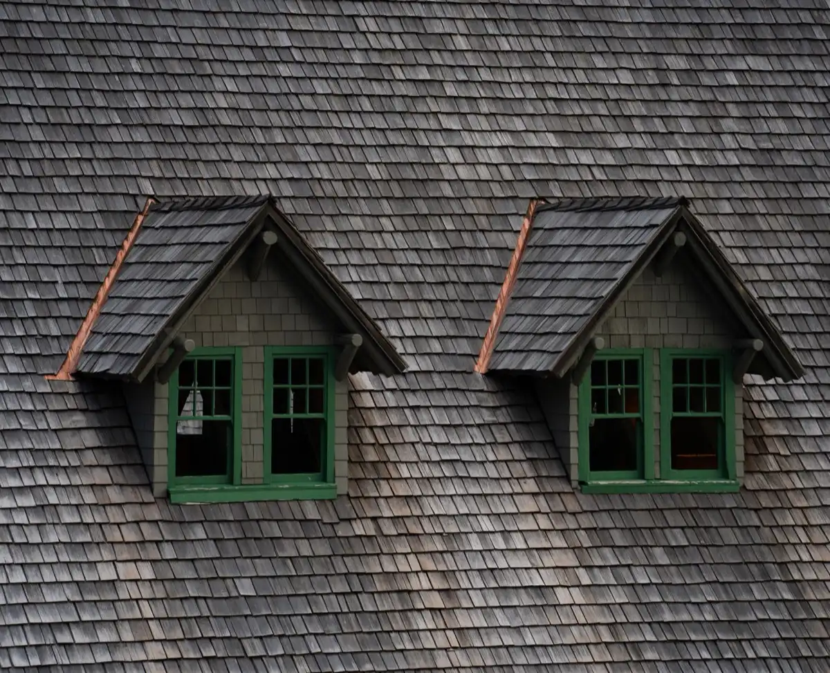 Dormers on a shingle roof in Conroe, TX, where step flashing and kickout flashing carry water past the walls